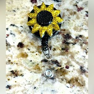Gold and black sunflower badge reel.